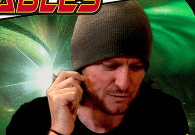 a man with a beanie on scowls and says don't worry it's for the breast