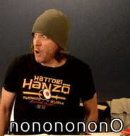 a man with a beanie on recoils towards the right side of the image